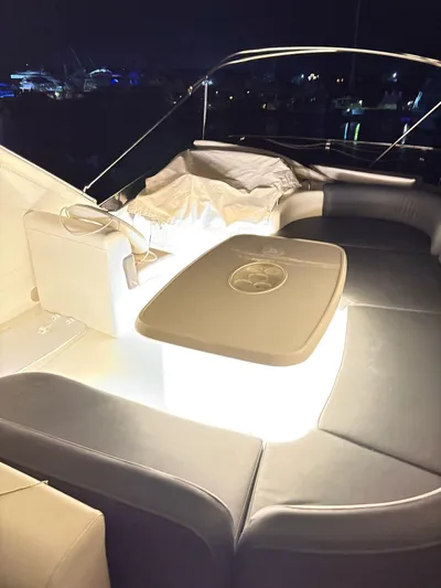  Yacht Photos Pics Luxurious 2004 Azimut 62 Flybridge yacht interior with illuminated seating area at night.
