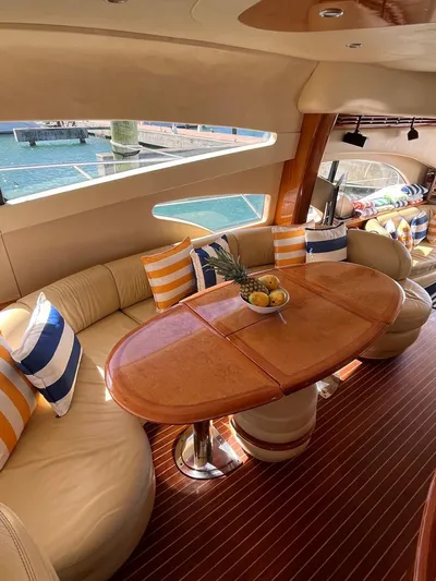  Yacht Photos Pics Luxurious 2004 Azimut 62 Flybridge yacht interior with elegant seating and striped cushions.