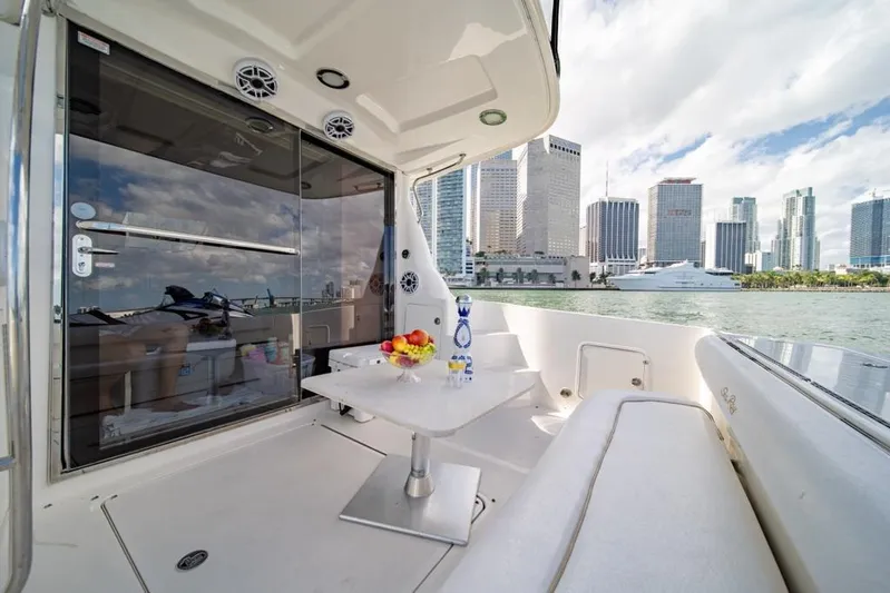  Yacht Photos Pics 2006 Sea Ray 52 Sedan Bridge yacht with city skyline view, featuring outdoor seating and table.