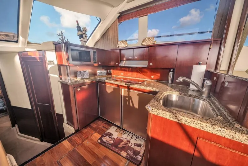  Yacht Photos Pics Luxurious kitchen interior of 2006 Sea Ray 52 Sedan Bridge yacht with granite countertops.