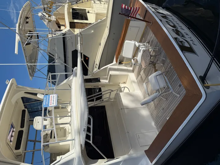 Escape Yacht Photos Pics 1998 Ocean Yachts 53 Super Sport at dock with seating area.