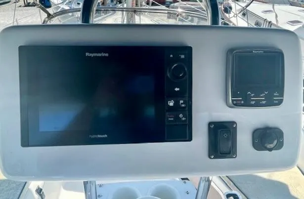 Gypsy Palace Yacht Photos Pics Control panel of a 2003 Hunter Passage 420 sailboat with Raymarine navigation equipment.