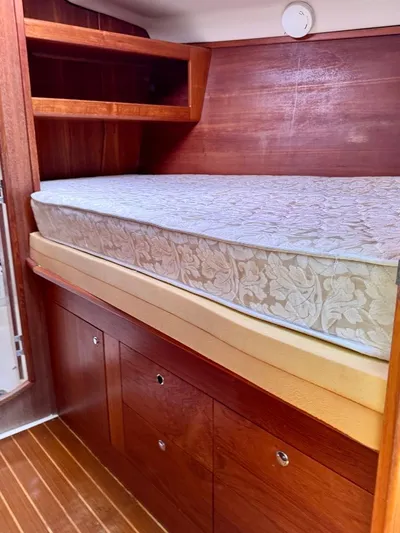 Gypsy Palace Yacht Photos Pics Interior cabin of 2003 Hunter Passage 420 sailboat with wooden storage and mattress.