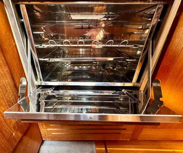 Gypsy Palace Yacht Photos Pics Open stainless steel oven inside a 2003 Hunter Passage 420 yacht kitchen.