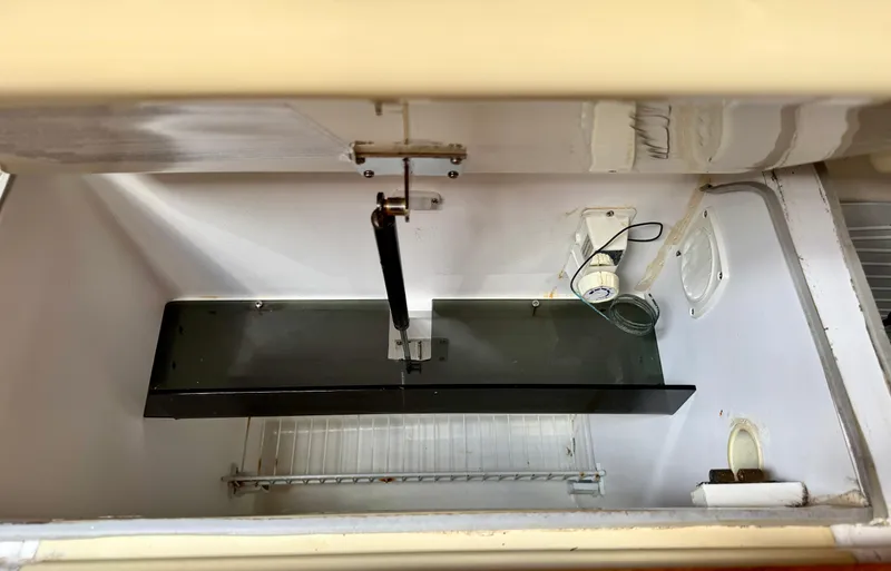 Gypsy Palace Yacht Photos Pics Interior view of a 2003 Hunter Passage 420 refrigerator with shelving and wiring.