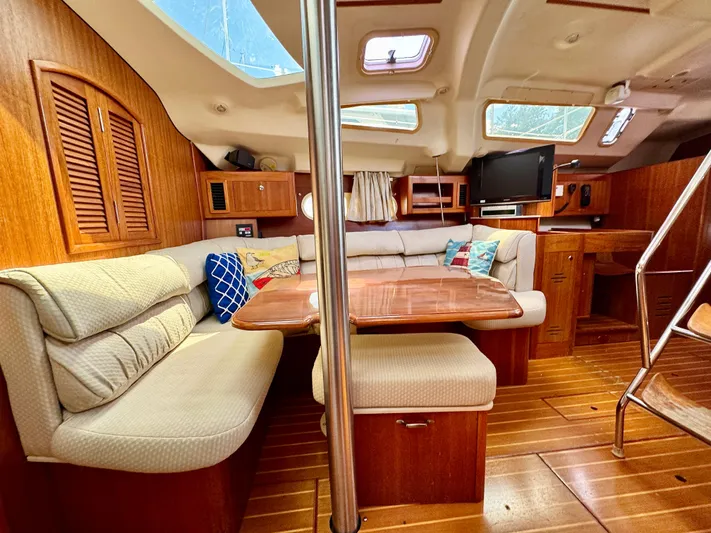 Gypsy Palace Yacht Photos Pics Interior of 2003 Hunter Passage 420 yacht with cozy seating and wooden finishes.
