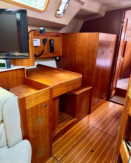 Gypsy Palace Yacht Photos Pics Interior of a 2003 Hunter Passage 420 sailboat with wooden cabinetry and seating area.