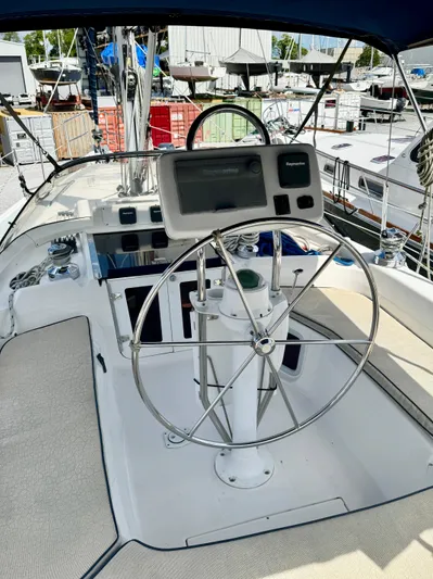 Gypsy Palace Yacht Photos Pics 2003 Hunter Passage 420 yacht cockpit with steering wheel and navigation system.