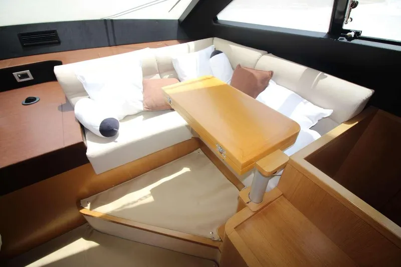  Yacht Photos Pics Luxurious interior of 2006 Ferretti Yachts 780 with cozy seating and wooden table.