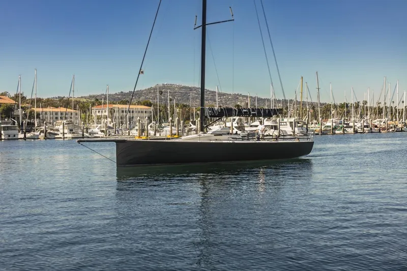 Ground Hog Day Yacht Photos Pics Sleek 2007 Rogers 46 sailboat docked in a marina under clear blue skies.