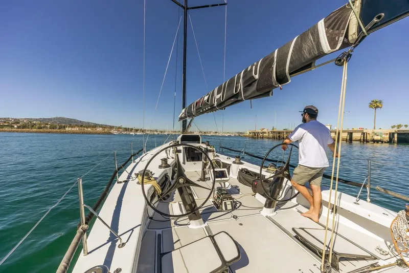 Ground Hog Day Yacht Photos Pics Sailboat Rogers 46, 2007 model, navigating calm waters under clear blue skies.