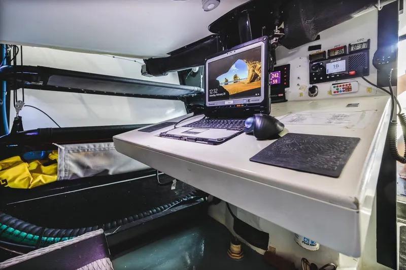 Ground Hog Day Yacht Photos Pics Navigation station inside a 2007 Rogers 46 yacht with laptop and control panels.