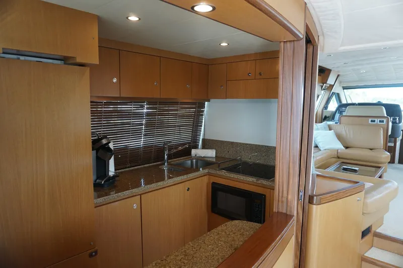 Motor Mile Marine Yacht Photos Pics Luxurious kitchen interior of 2008 Ferretti Yachts 630 with modern amenities and wood finish.