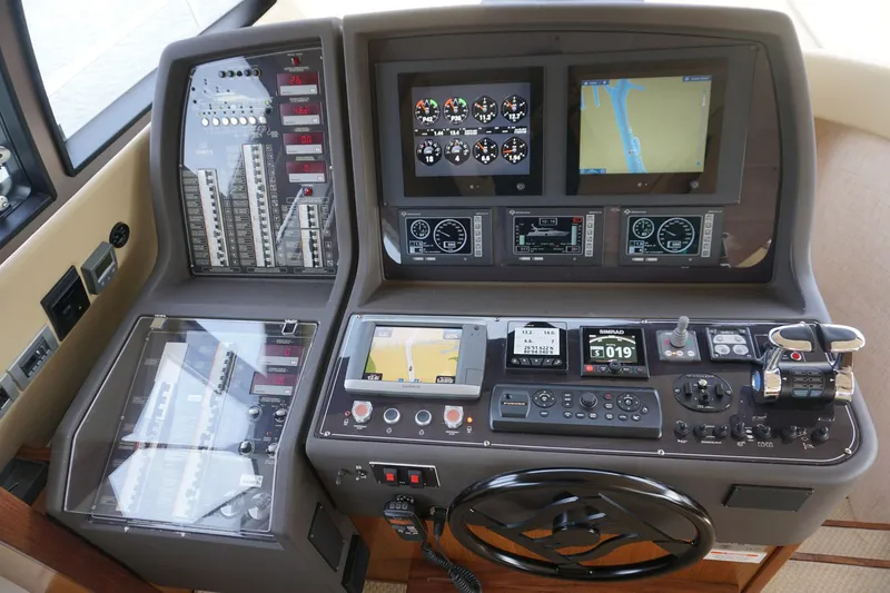 Motor Mile Marine Yacht Photos Pics Control panel of a 2008 Ferretti Yachts 630 with navigation screens and instruments.
