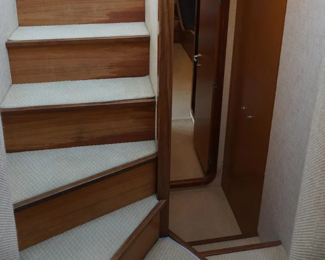Motor Mile Marine Yacht Photos Pics Staircase and hallway inside 2008 Ferretti Yachts 630, featuring wooden steps and carpet.