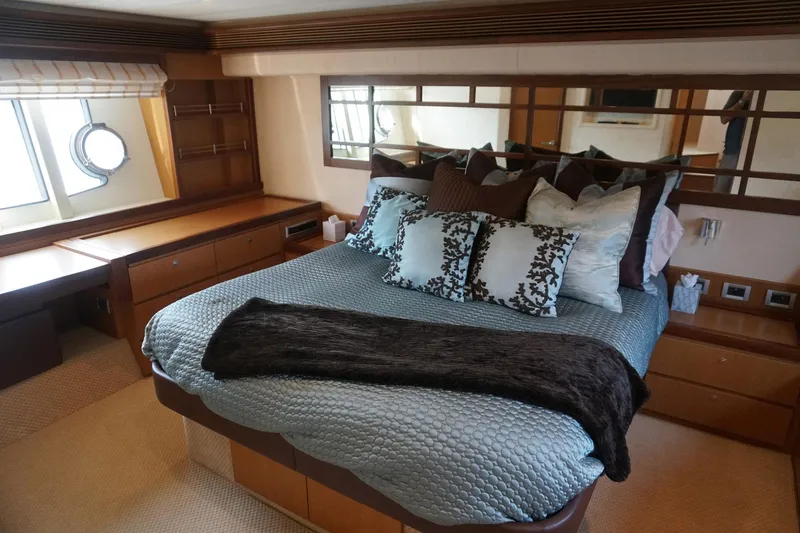 Motor Mile Marine Yacht Photos Pics Luxurious bedroom interior of 2008 Ferretti Yachts 630 with elegant bedding and wood accents.