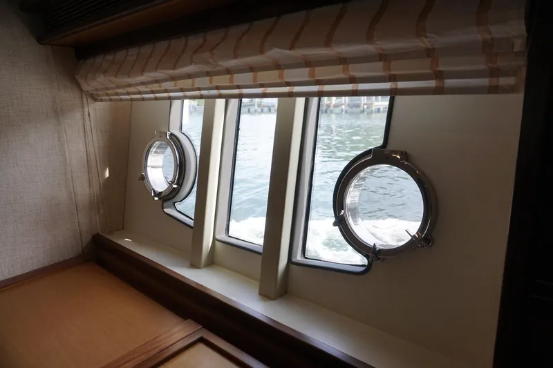 Motor Mile Marine Yacht Photos Pics Interior view of 2008 Ferretti Yachts 630 with porthole windows overlooking water.