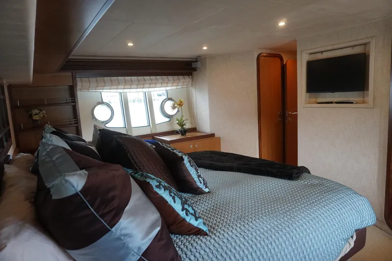 Motor Mile Marine Yacht Photos Pics Luxurious bedroom interior of 2008 Ferretti Yachts 630 with elegant bedding and porthole windows.