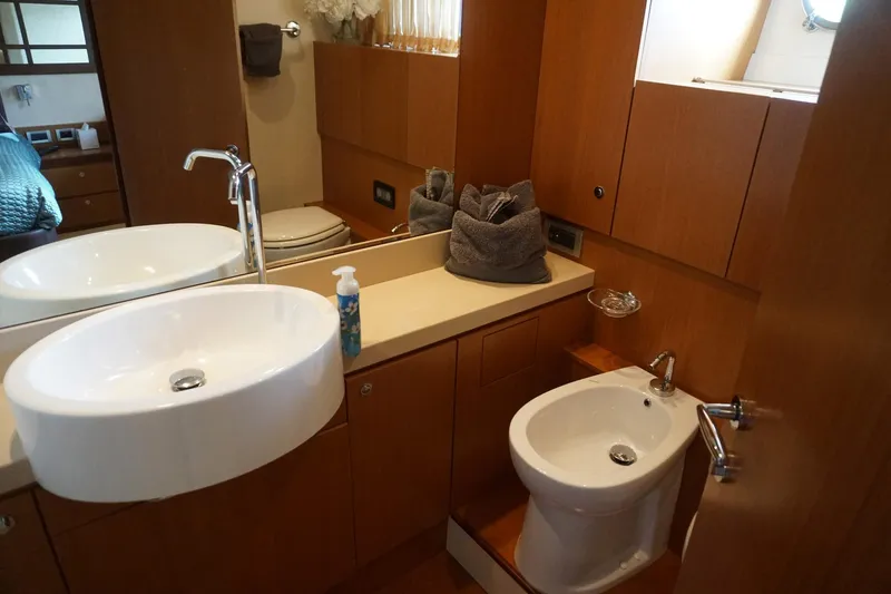 Motor Mile Marine Yacht Photos Pics Luxurious bathroom in 2008 Ferretti Yachts 630, featuring modern sink and bidet.