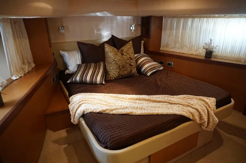 Motor Mile Marine Yacht Photos Pics Luxurious bedroom interior of 2008 Ferretti Yachts 630 with elegant bedding and decor.