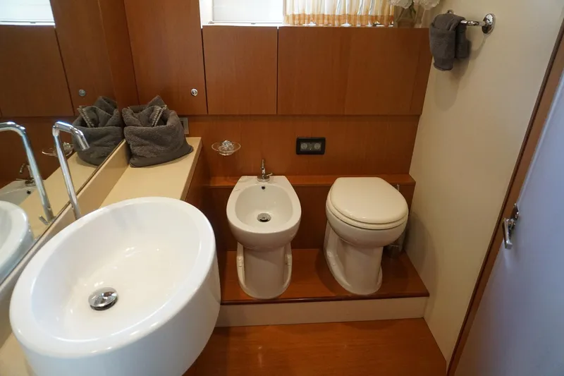Motor Mile Marine Yacht Photos Pics Luxurious bathroom in 2008 Ferretti Yachts 630, featuring modern fixtures and elegant wood paneling.