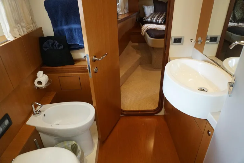 Motor Mile Marine Yacht Photos Pics Luxurious bathroom interior of 2008 Ferretti Yachts 630, featuring modern fixtures and wooden accents.