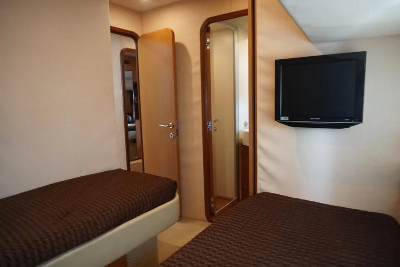 Motor Mile Marine Yacht Photos Pics Luxurious cabin interior of 2008 Ferretti Yachts 630 with twin beds and wall-mounted TV.