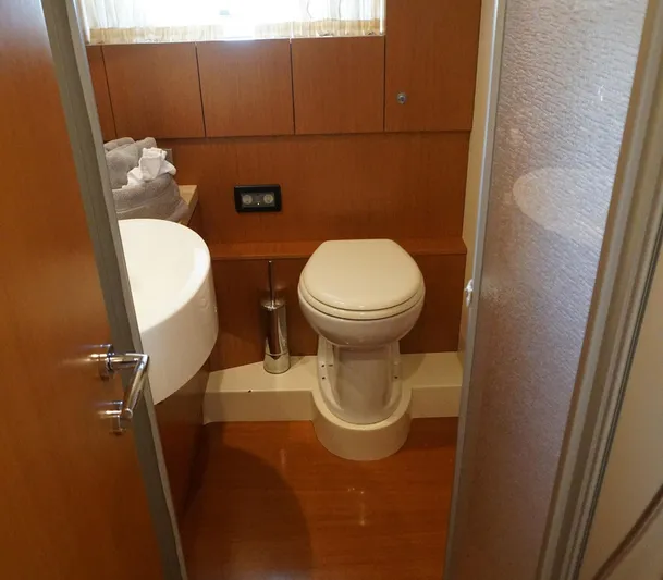 Motor Mile Marine Yacht Photos Pics Bathroom interior of 2008 Ferretti Yachts 630, featuring modern fixtures and wood paneling.