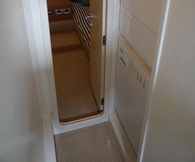 Motor Mile Marine Yacht Photos Pics Hallway inside 2008 Ferretti Yachts 630, leading to a cabin with striped bedding.