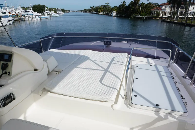 Motor Mile Marine Yacht Photos Pics Flybridge view of 2008 Ferretti Yachts 630, featuring sunbathing area and scenic waterfront.