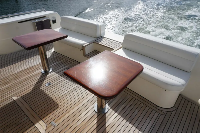 Motor Mile Marine Yacht Photos Pics Luxury Ferretti Yachts 630 deck with wooden tables and white seating, 2008 model.