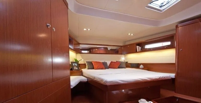 Freedom Yacht Photos Pics Luxurious cabin interior of 2011 Beneteau Oceanis 58 yacht with wood finish and cozy bedding.