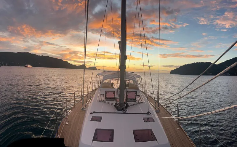 Freedom Yacht Photos Pics Beneteau Oceanis 58 sailing at sunset, 2011 model, with scenic ocean view.