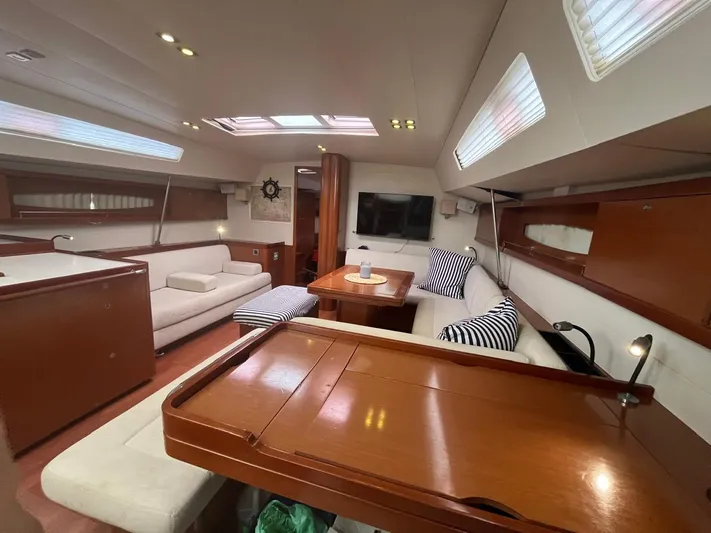 Freedom Yacht Photos Pics Luxurious interior of 2011 Beneteau Oceanis 58 yacht with elegant seating and wooden finishes.