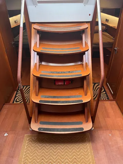 Freedom Yacht Photos Pics Staircase inside 2011 Beneteau Oceanis 58 yacht with wooden steps and handrails.