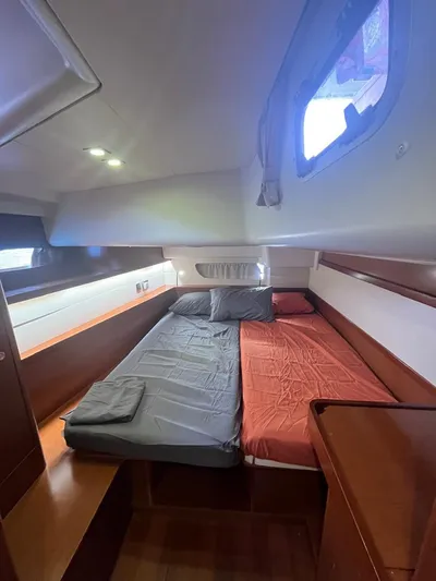 Freedom Yacht Photos Pics Interior cabin of 2011 Beneteau Oceanis 58 yacht with twin beds and wooden furnishings.