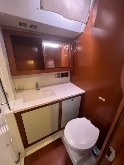 Freedom Yacht Photos Pics Bathroom interior of 2011 Beneteau Oceanis 58 yacht, featuring sink and toilet.