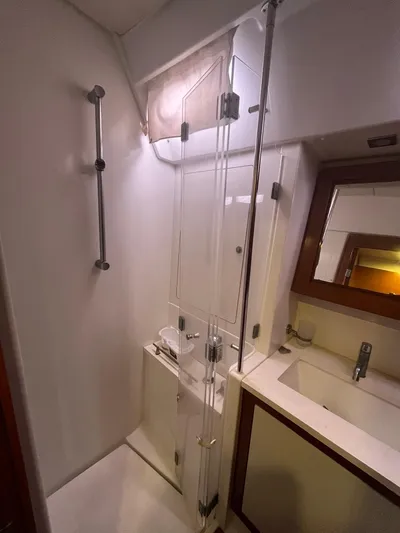 Freedom Yacht Photos Pics 2011 Beneteau Oceanis 58 bathroom with shower, sink, and mirror.