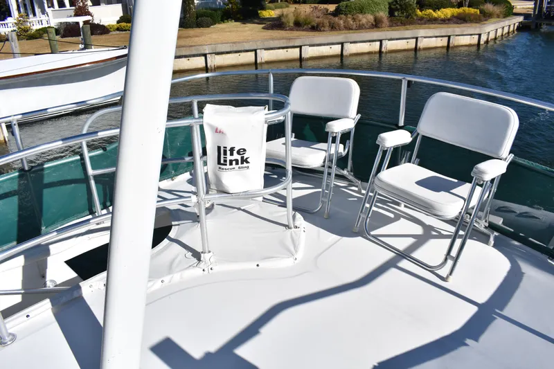  Yacht Photos Pics 2001 Mainship 390 boat deck with chairs and Life Link rescue sling.