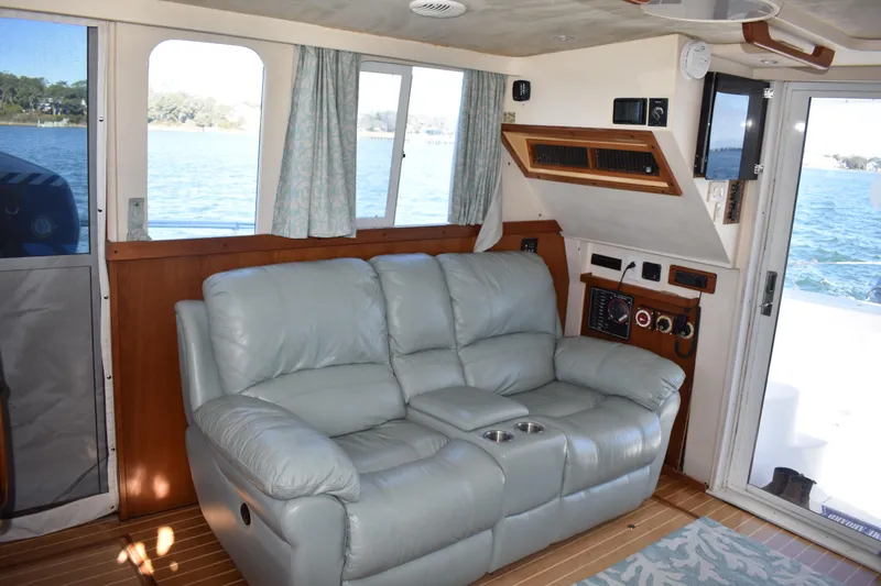  Yacht Photos Pics Interior of 2001 Mainship 390 yacht with leather sofa and ocean view.