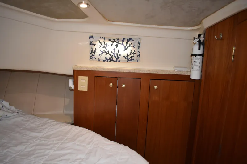  Yacht Photos Pics Cozy cabin interior of 2001 Mainship 390 with wooden cabinets and nautical decor.