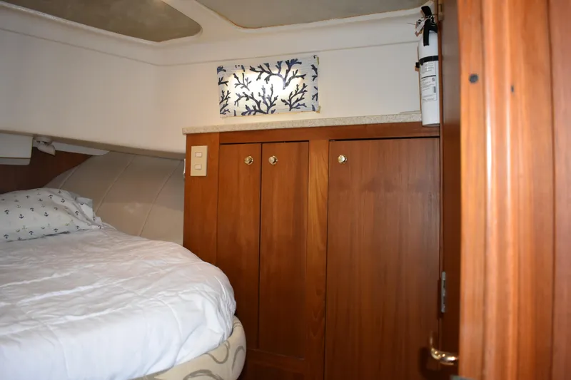  Yacht Photos Pics 2001 Mainship 390 cabin interior with bed, wooden cabinets, and nautical decor.