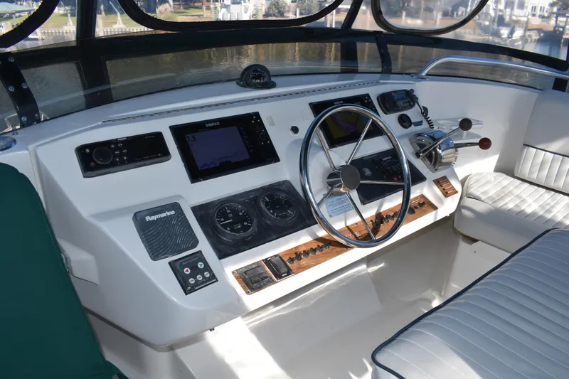 Yacht Photos Pics Helm of 2001 Mainship 390 with navigation instruments and steering wheel.