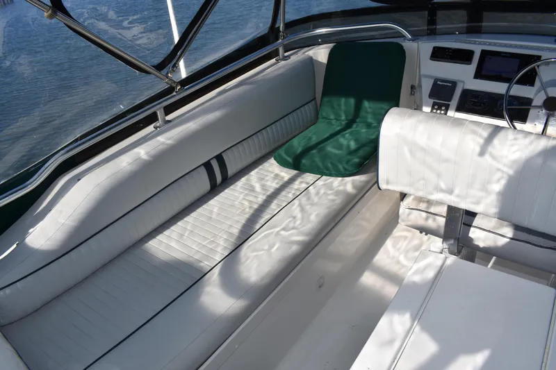  Yacht Photos Pics 2001 Mainship 390 boat interior with white seating and green cushion.