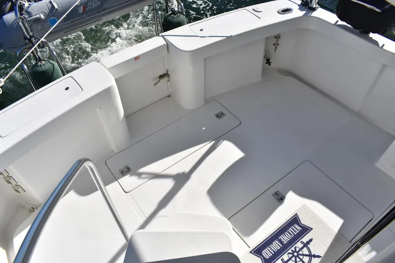  Yacht Photos Pics 2001 Mainship 390 boat deck with storage hatches and nautical-themed mat.