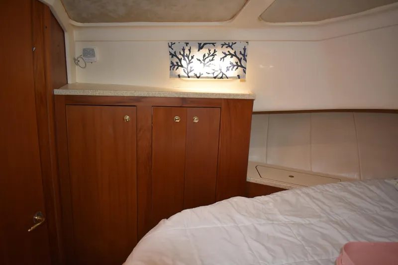  Yacht Photos Pics 2001 Mainship 390 cabin interior with wooden cabinets and decorative wall art.
