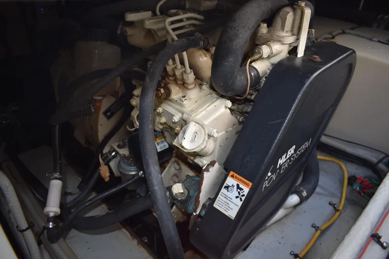  Yacht Photos Pics Engine compartment of a 2001 Mainship 390 boat, showcasing mechanical components and hoses.