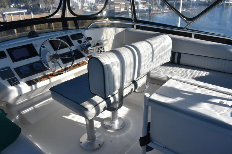  Yacht Photos Pics 2001 Mainship 390 yacht helm with steering wheel and cushioned seating.