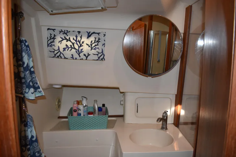  Yacht Photos Pics Bathroom interior of 2001 Mainship 390 yacht with mirror and toiletries.