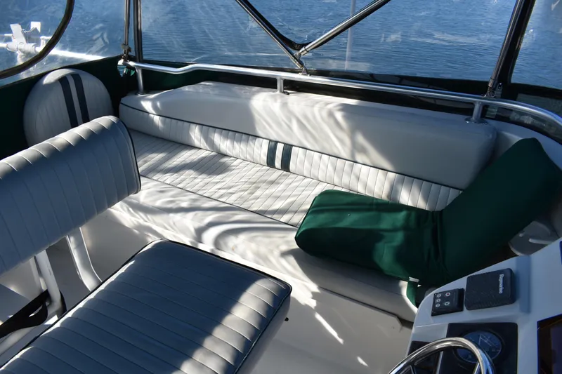  Yacht Photos Pics Interior seating of 2001 Mainship 390 boat with cushioned seats and green accents.